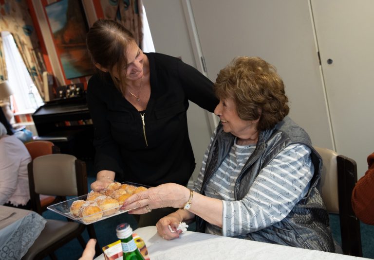 Tenant & Volunteer celebrating Chanukah-at-Cecil-Rosen-Court.
