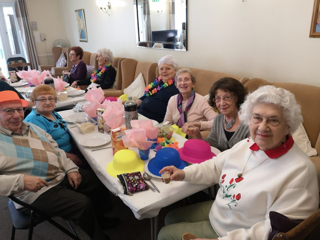 Tenants enjoying Purim meal --Francis & Dick James Court