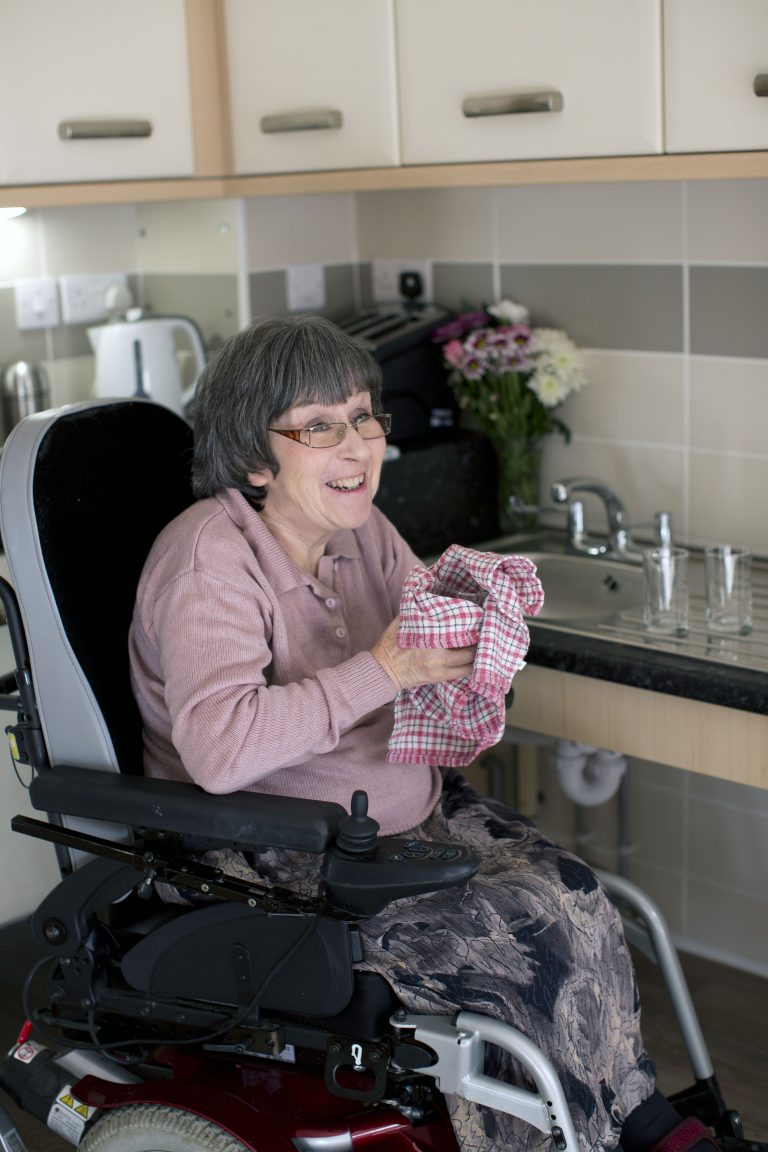 Denise in wheelchair adapted kitchen --Fairacres